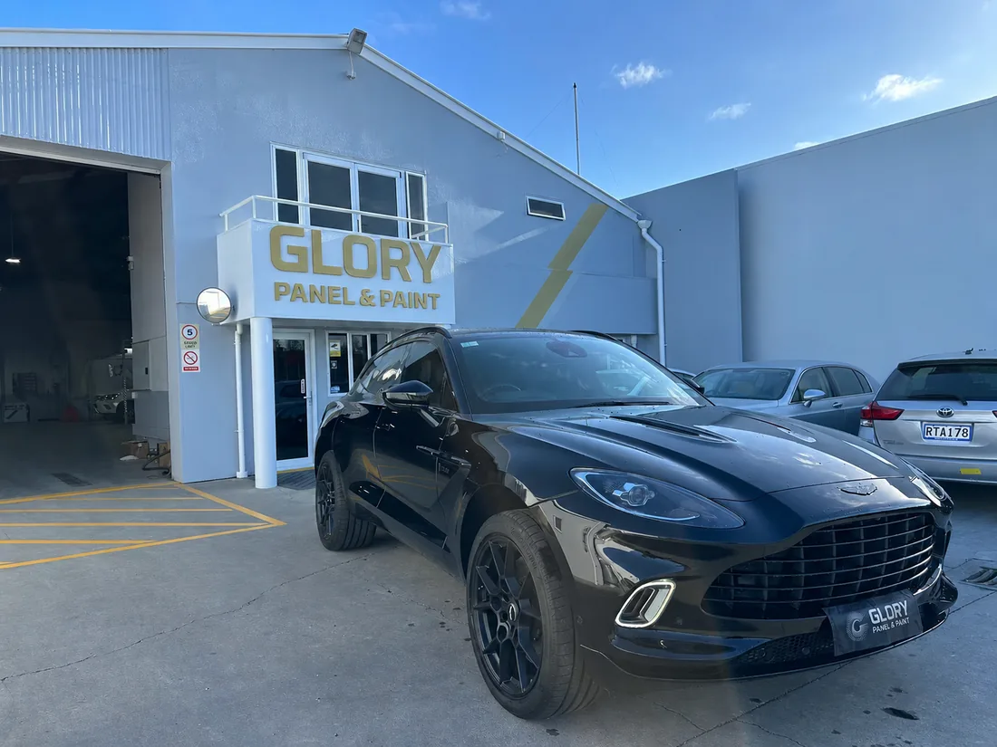 Black Aston Martin DBX outside GLORY Panel & Paint, Hornby Christchurch